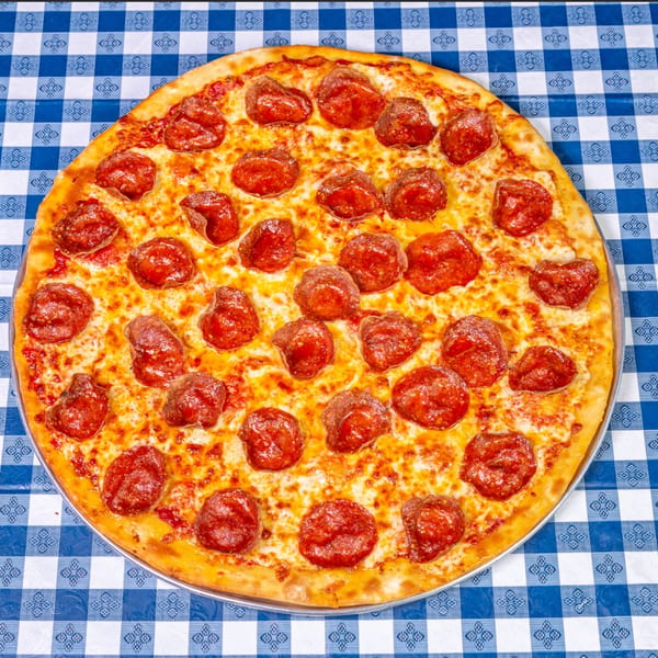 A Big Dog's Pizza pepperoni pizza on a blue and white checkered tablecloth.